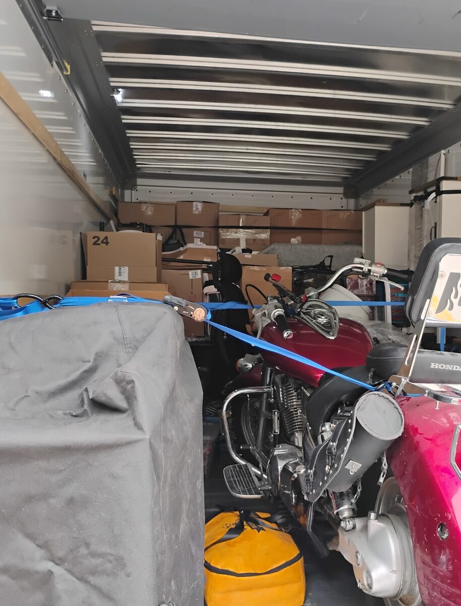 Motorcycle secured for transport inside a moving truck