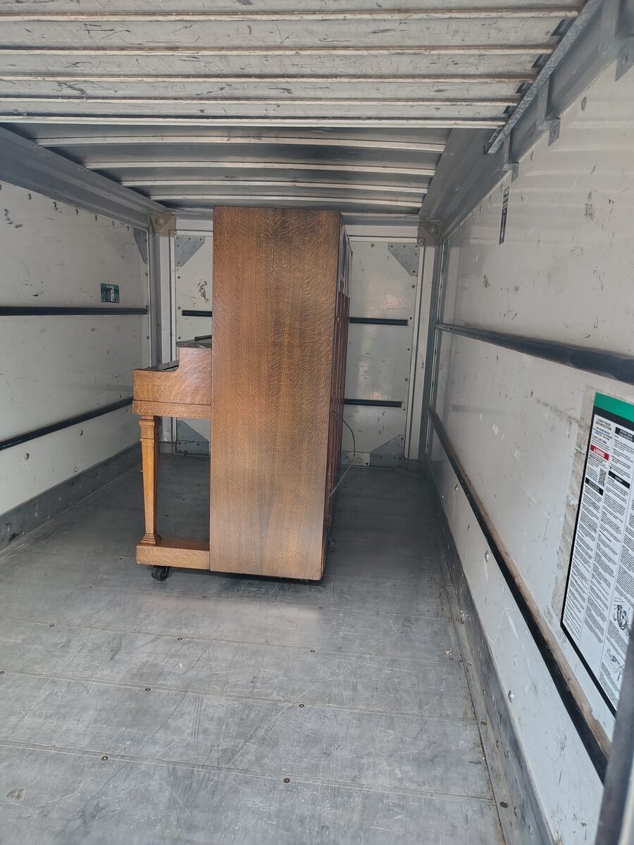 Upright piano loaded into a customer's trailer with help from We Move You LLC